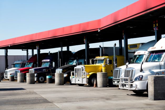 Trucks lined up at a gas station