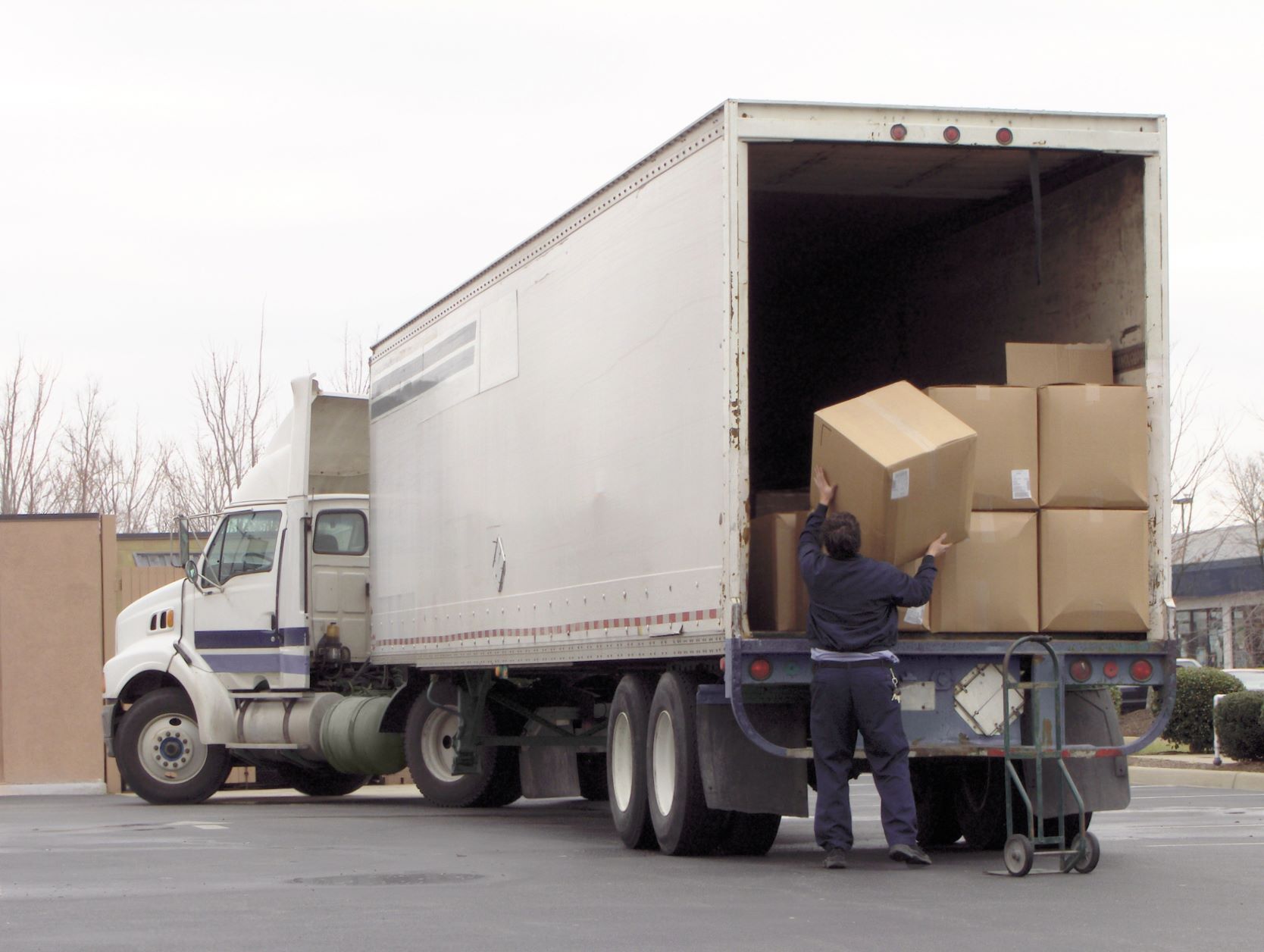 A man loading a truck with boxes